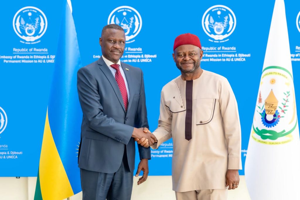 Ambassador Charles Karamba and Mr. Ozonnia Ojielo shake hands during an official courtesy meeting.